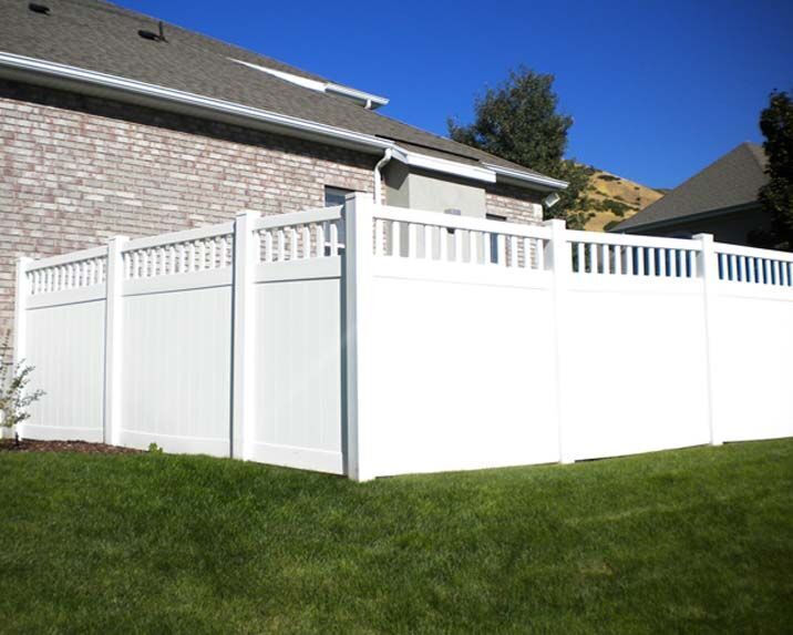 White vinyl privacy fence with an open baluster accent top