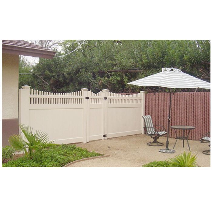 Tan vinyl privacy fence with picket topper and gate at a patio