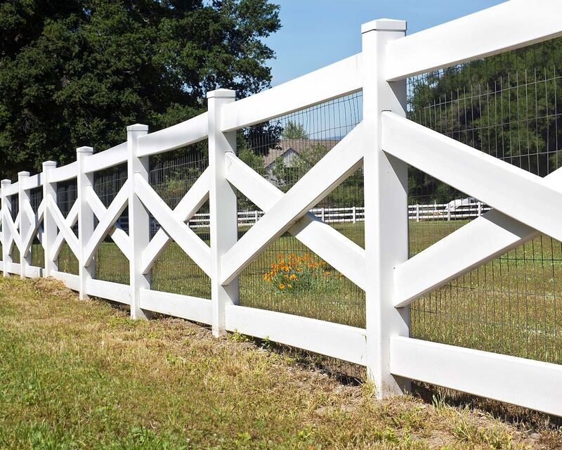 White vinyl crossbuck ranch fence with wire mesh backing