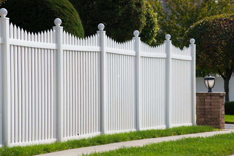 Tall white vinyl scalloped picket fence with ball post caps