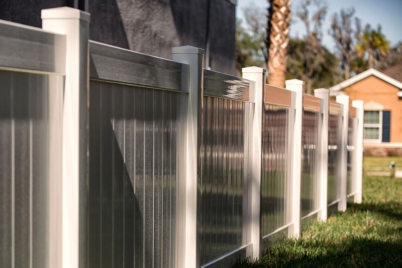 Two-tone vinyl privacy fence with gray panels and white posts