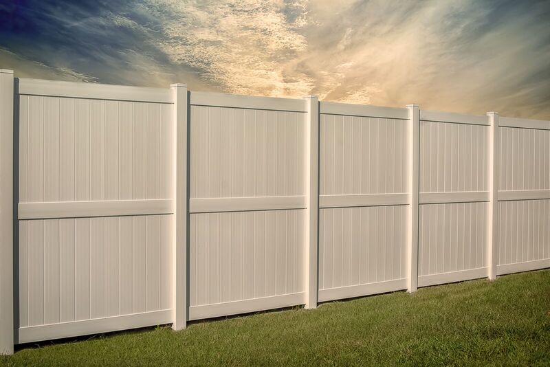 White vinyl privacy fence with eight-by-six two-rail panels