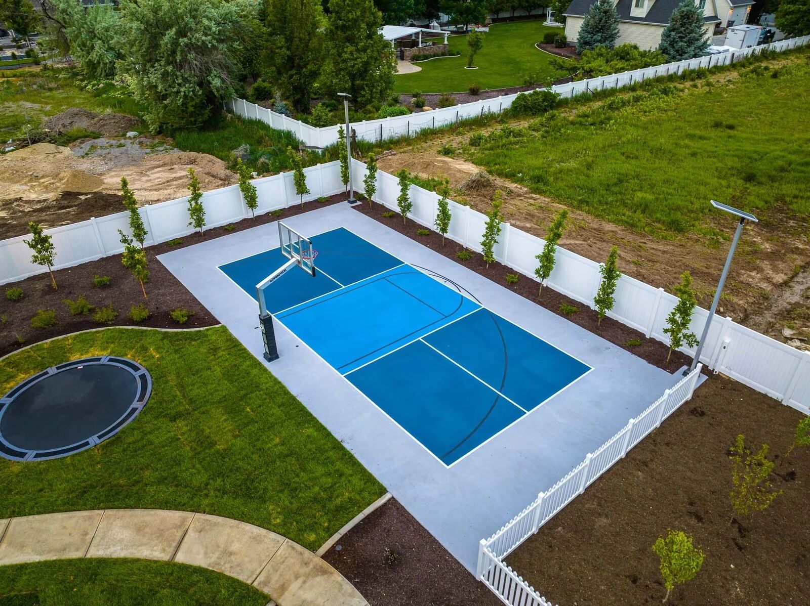 Privacy fence enclosing a backyard sport court